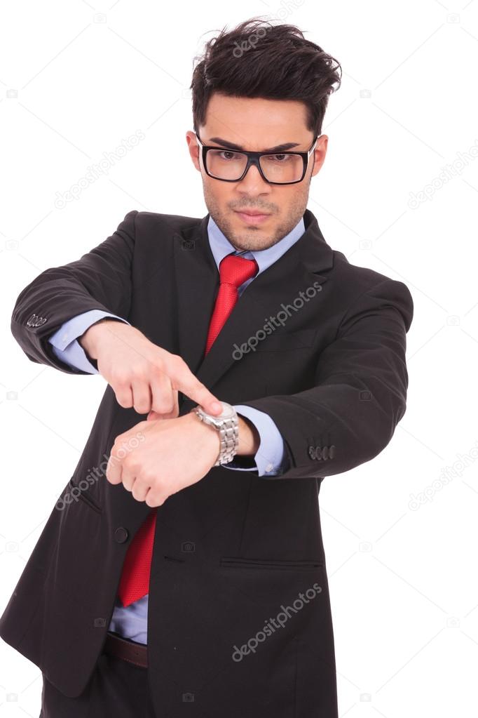 man pointing to his watch