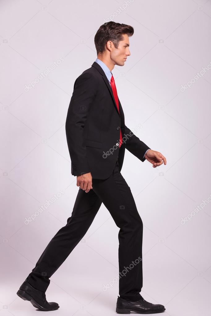side view of man walking & looking away