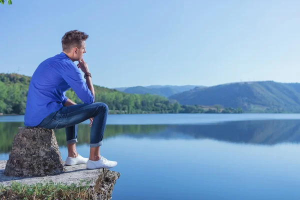 Pensive man by the lake — Stock Photo, Image