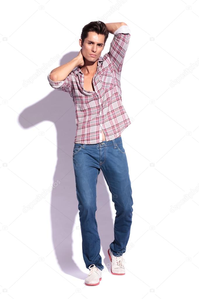 Young man posing with hand behind head on black background Royalty-Free  Stock Image - Storyblocks