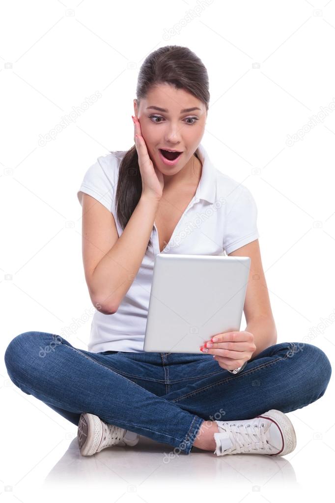 casual woman sits shocked with pad