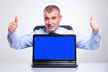 old business man shows laptop and thumbs up clipart