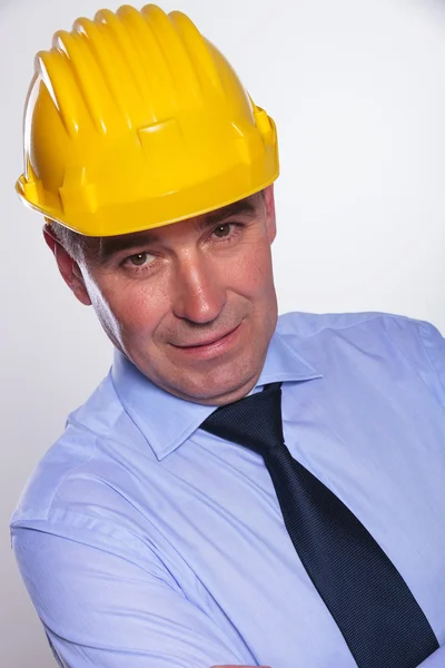 Alter Ingenieur mit Helm schaut einen an — Stockfoto