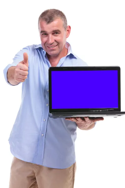 Casual middle aged man recommends laptop Stock Image