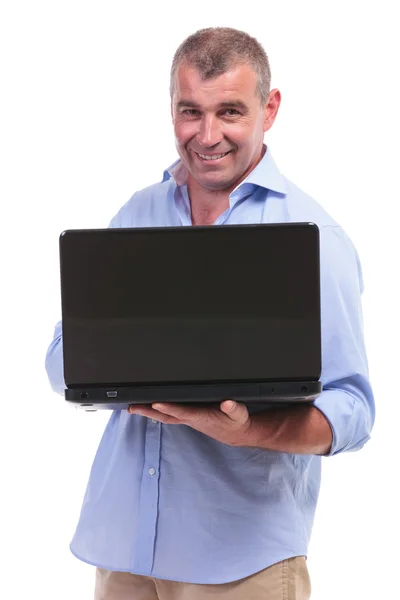 Casual middle aged man holding his laptop Royalty Free Stock Images