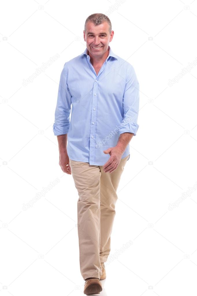 casual middle aged man walks to the camera