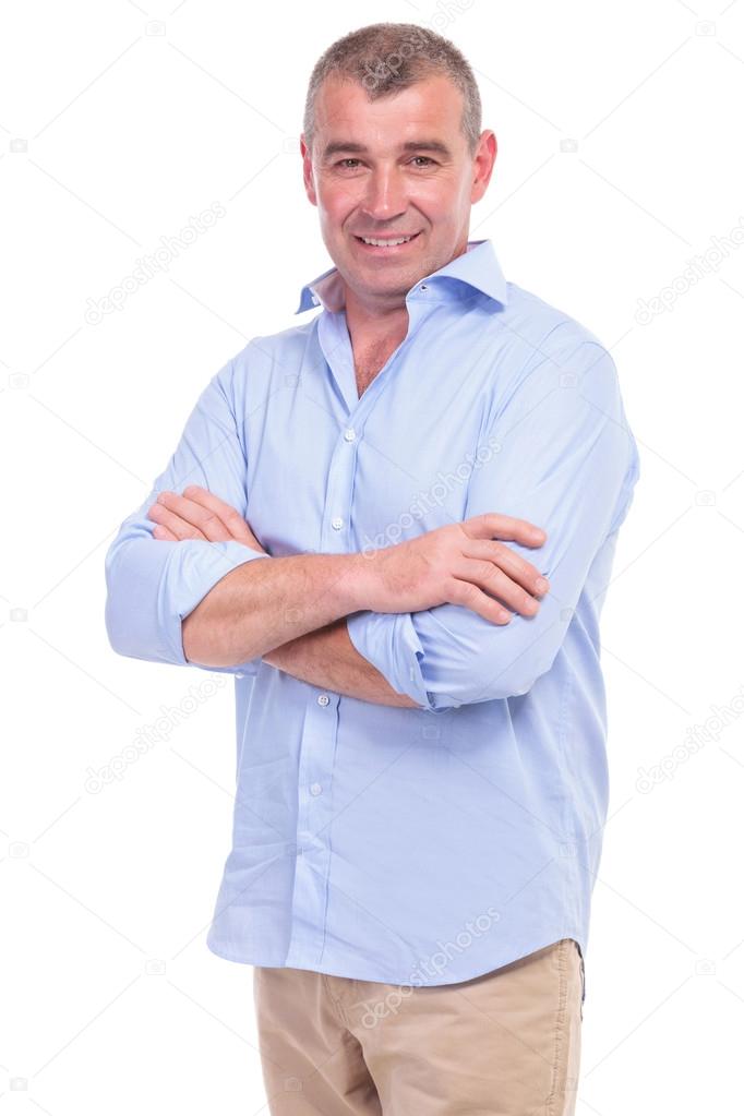 casual middle aged man has his arms crossed