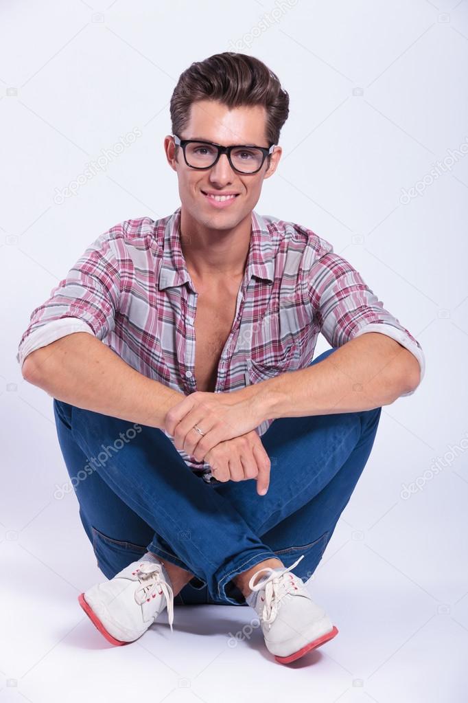 casual man sits with legs crossed