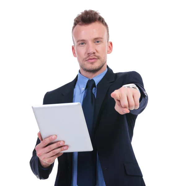 Business man holds tablet and points at you — Stock Photo, Image