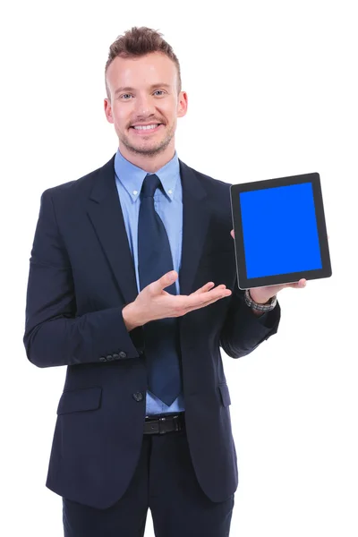 Business man presents a tablet with a smile — Stock Photo, Image