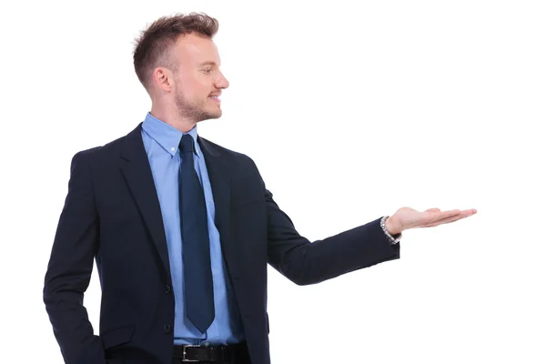 Business man looks at his opened palm — Stock Photo, Image