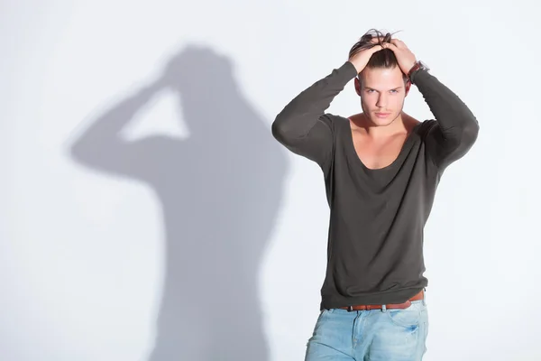 Casual man with both hands in hair — Stock Photo, Image