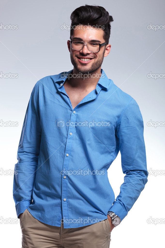 casual man smiles with hands in pockets