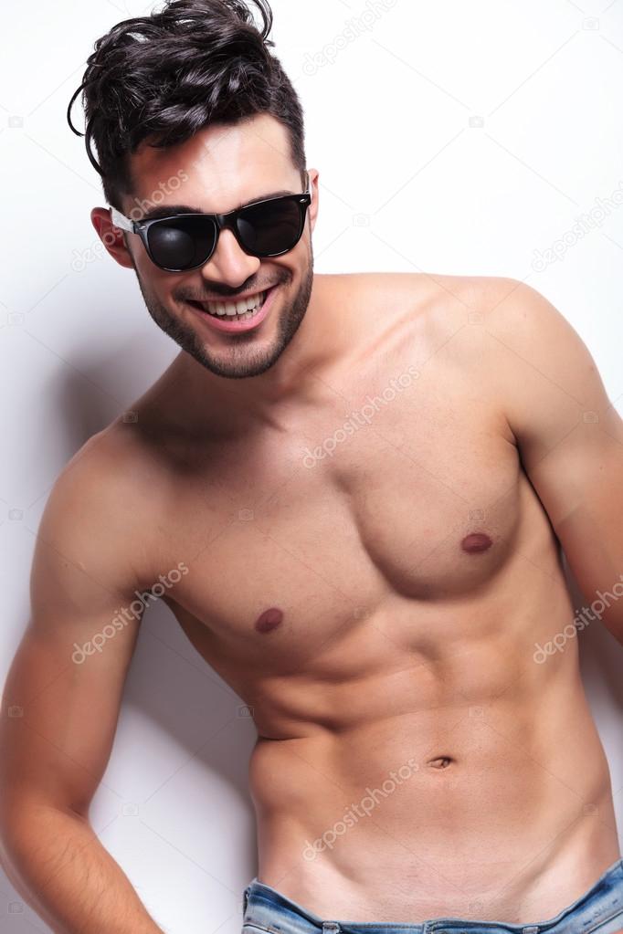 topless young man laughing