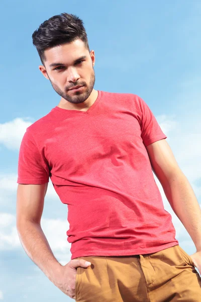 Casual man looks down with hand in pocket — Stock Photo, Image