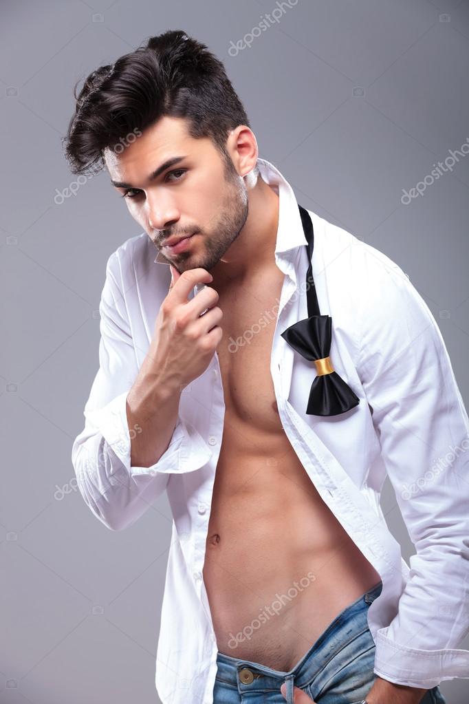 attractive young man touches his chin