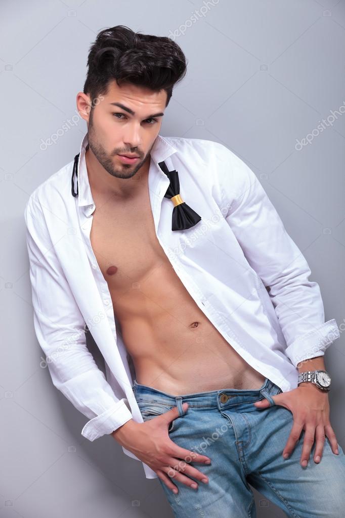 attractive young man with thumbs in jeans loops