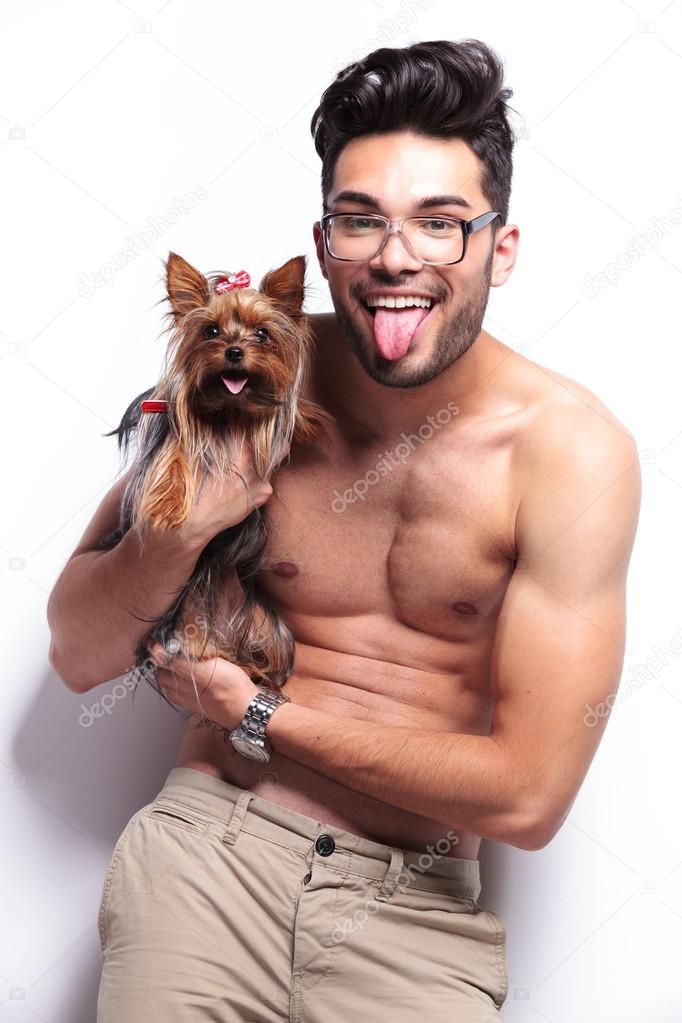 topless young man panting with puppy