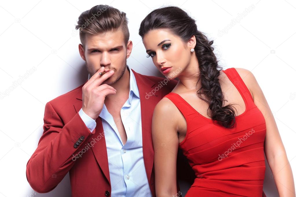 smoking hot fashion couple looking at the camera