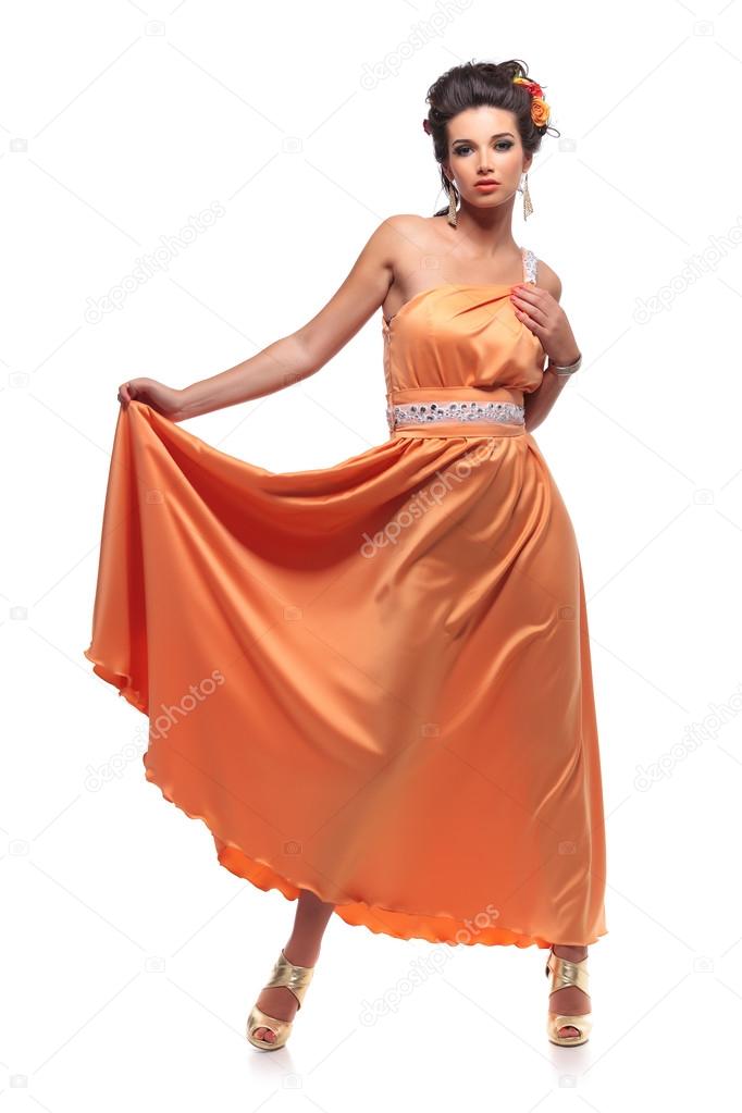 young attractive woman pulling her long dress