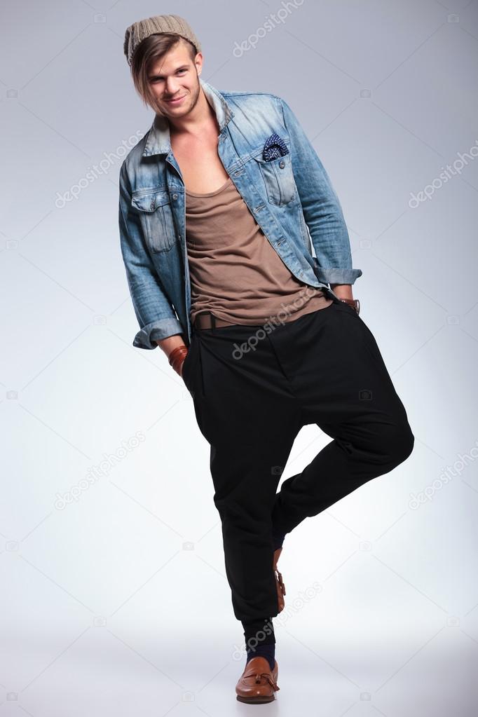 full length of casual man smiling on one leg