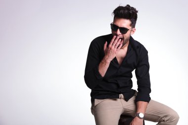 esneme oturan genç adam