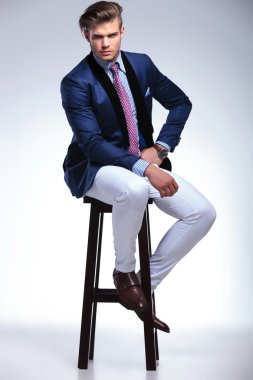 seated young business man with serious expression