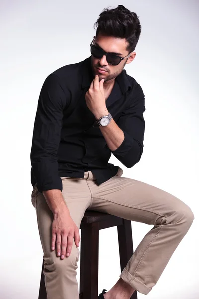 Young man sitting and thinking — Stock Photo, Image