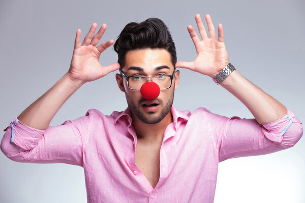 fashion young man with red nose acting crazy