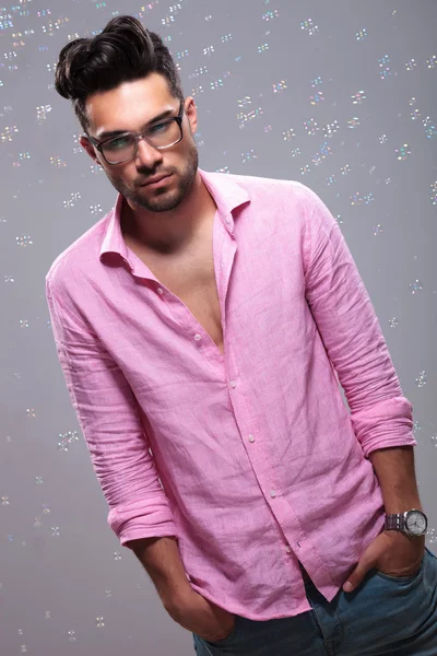 Young fashion man emotionless with bubbles around — Stock Photo, Image