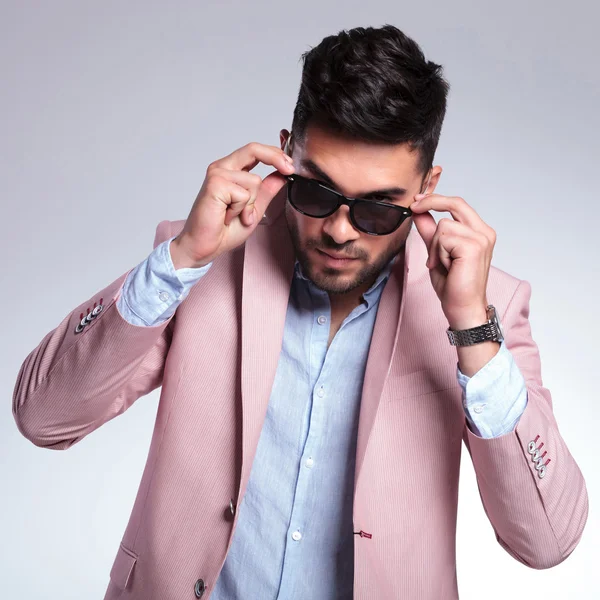 Fashion young man takes off his sunglasses — Stock Photo, Image