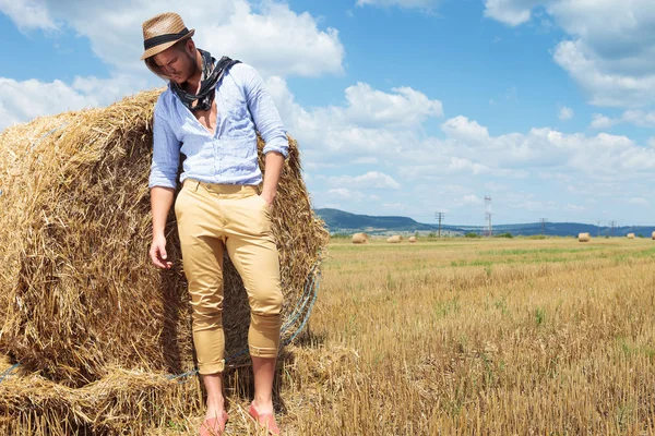 Casual man outdoor with hand in pocket looks down outside — Stock Photo, Image