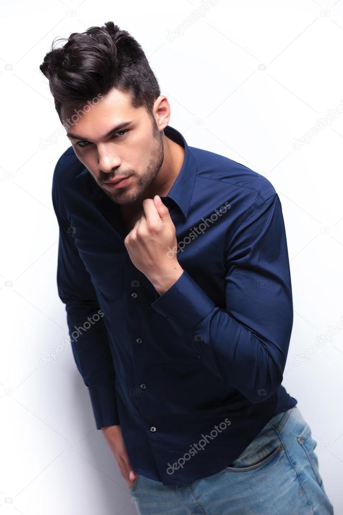 young man adjusts his shirt
