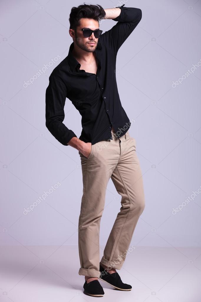Young fashion man poses with hand in Stock Photo by ©feedough 31401177