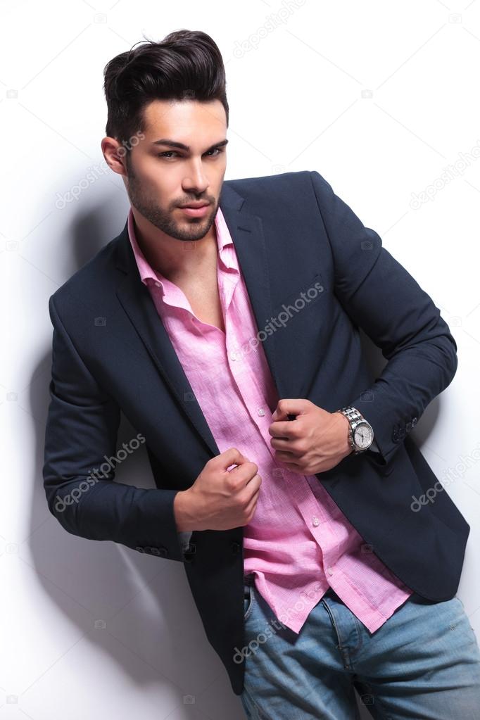 young fashion man holding hands on suit jacket