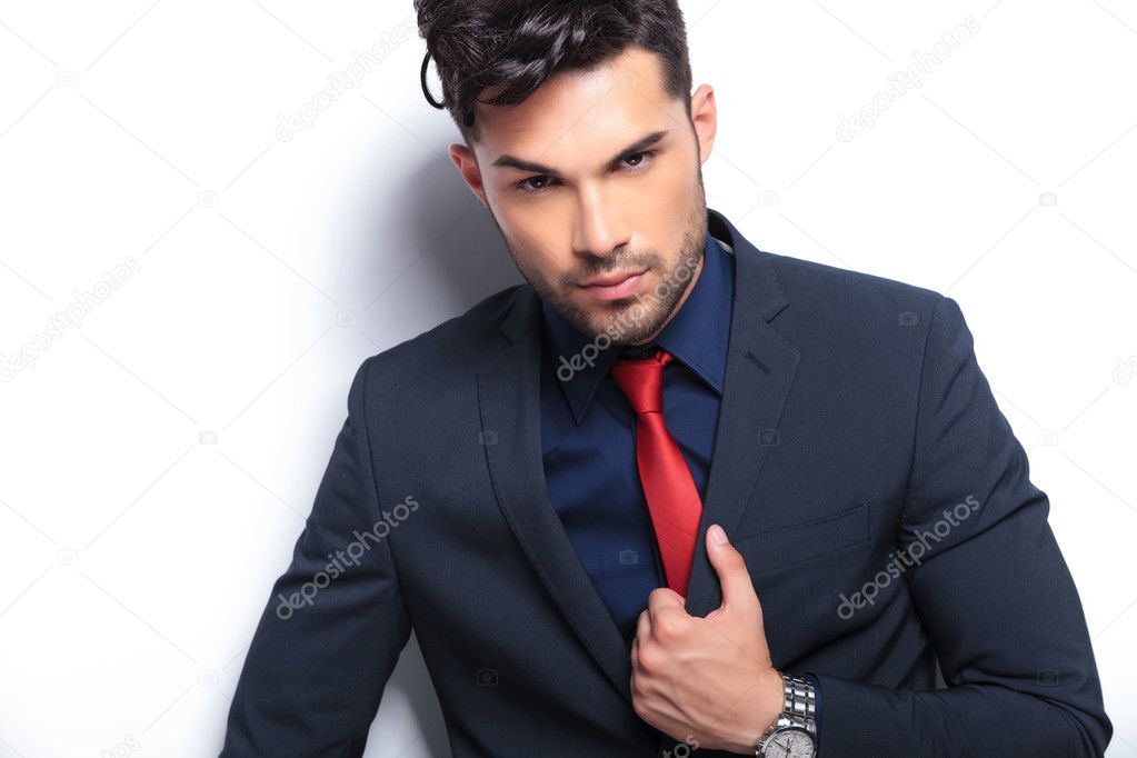 closeup of business man with hand on lapel