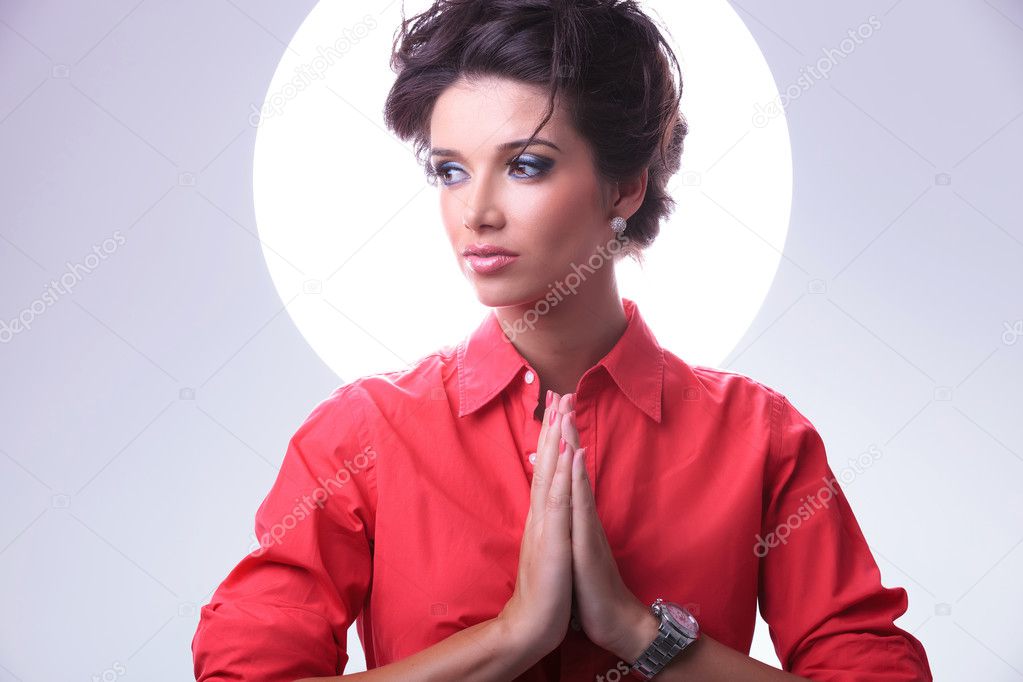 young woman with aura prays and looks away