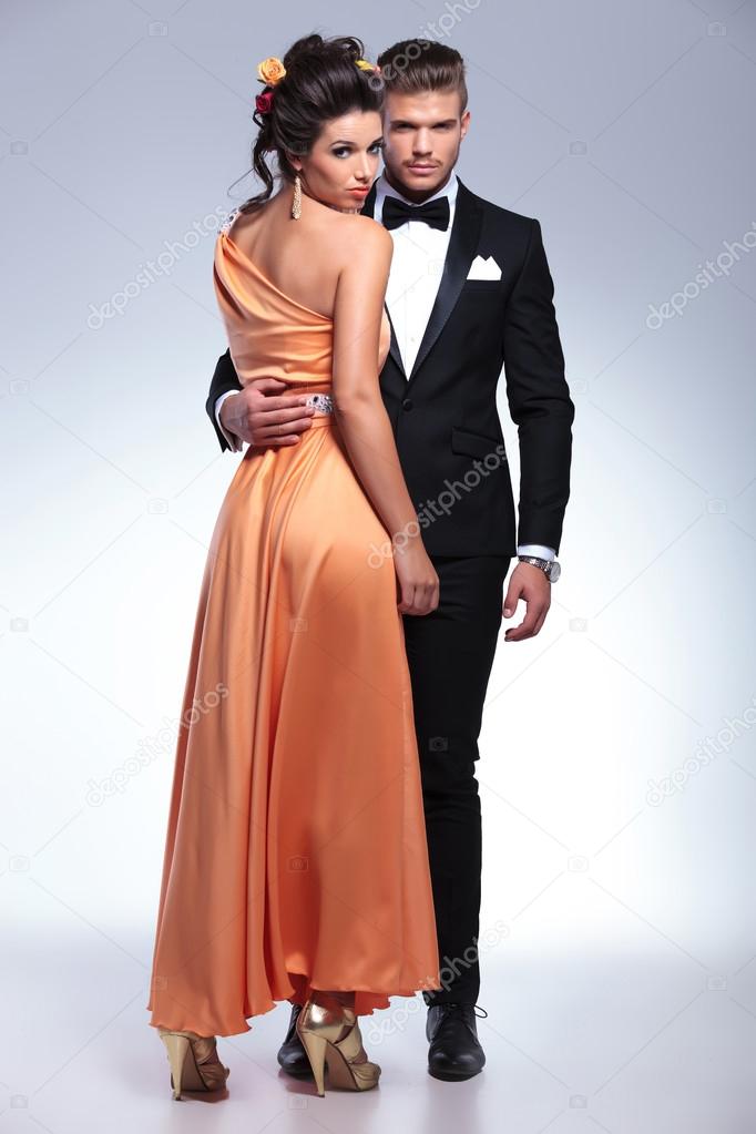 fashion couple with woman standing with back