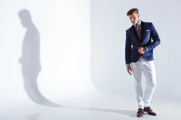 Joven hombre de negocios posando con la mano en la chaqueta —  Fotos de Stock