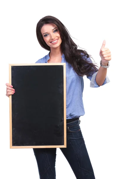 Casual woman with blackboard shows thumb up — Stock Photo, Image