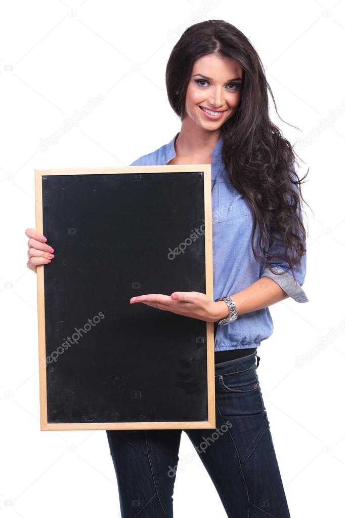 casual woman presents something on her blackboard