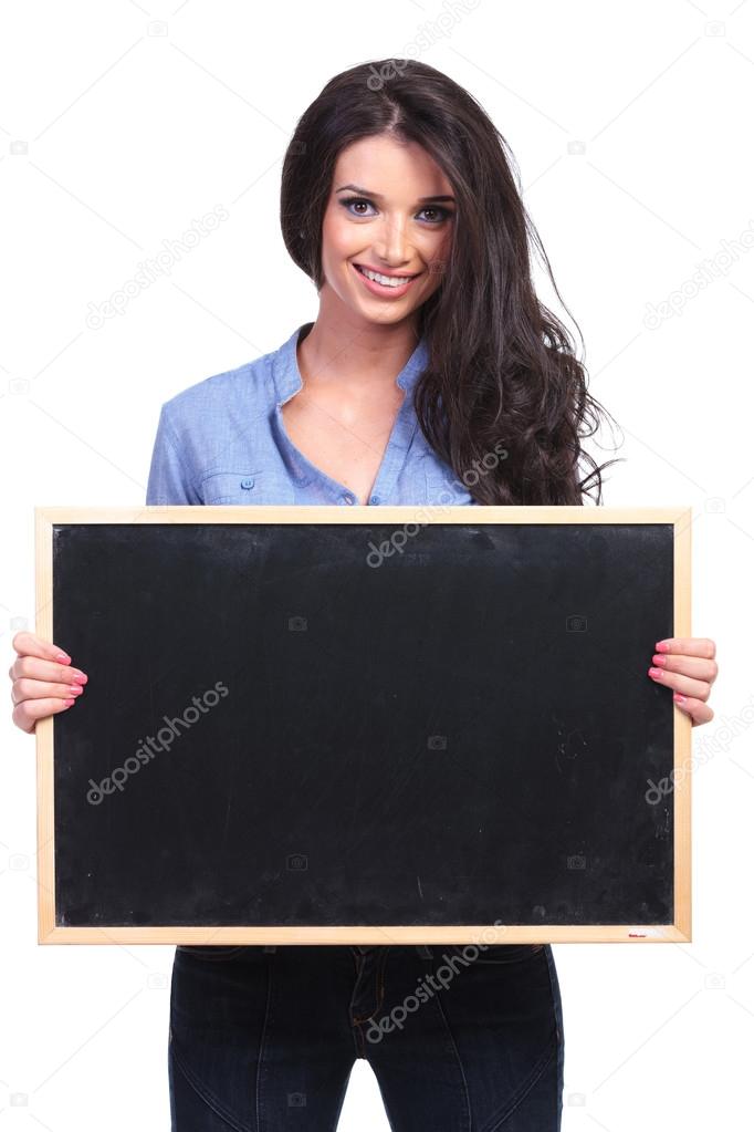 casual woman holds a blackboard with both hands