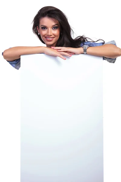 Casual woman behind a blank board — Stock Photo, Image