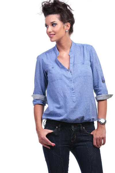Casual woman with thumbs in pockets looks away — Stock Photo, Image