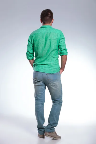 Back of a casual man with hands in pockets Stock Photo