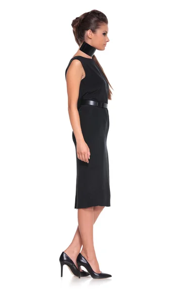 Side view of a young fashion woman in black dress — Stock Photo, Image