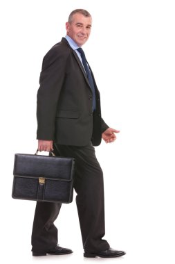 business man walks with his briefcase