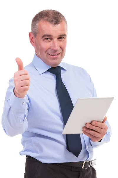 Business man shows thumb up with tablet in hand — Stock Photo, Image