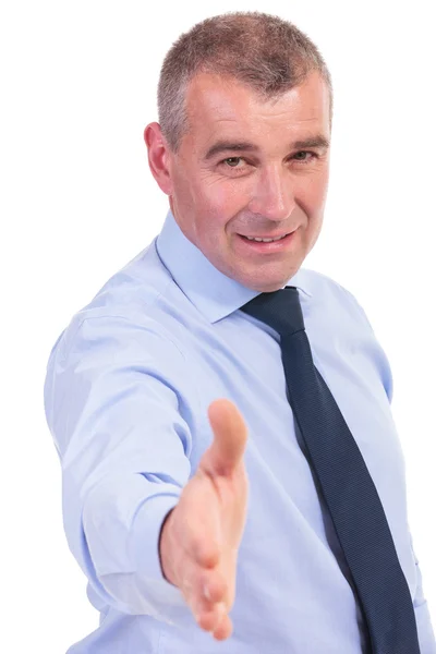 Business man offers a handshake and smiles — Stock Photo, Image