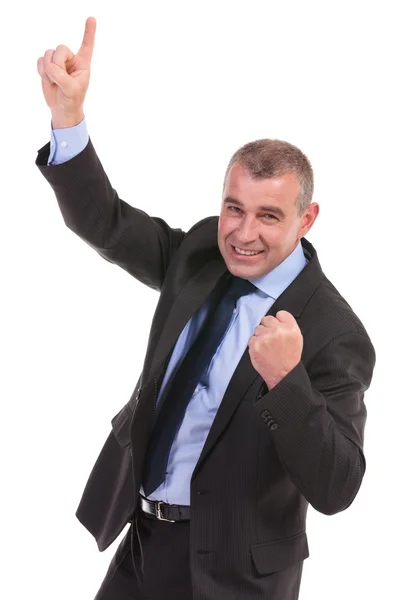 Business man cheers while pointing upward — Stock Photo, Image